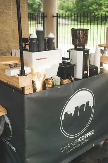 Espresso machine and grinder arranged on the Corner Coffee mobile cart