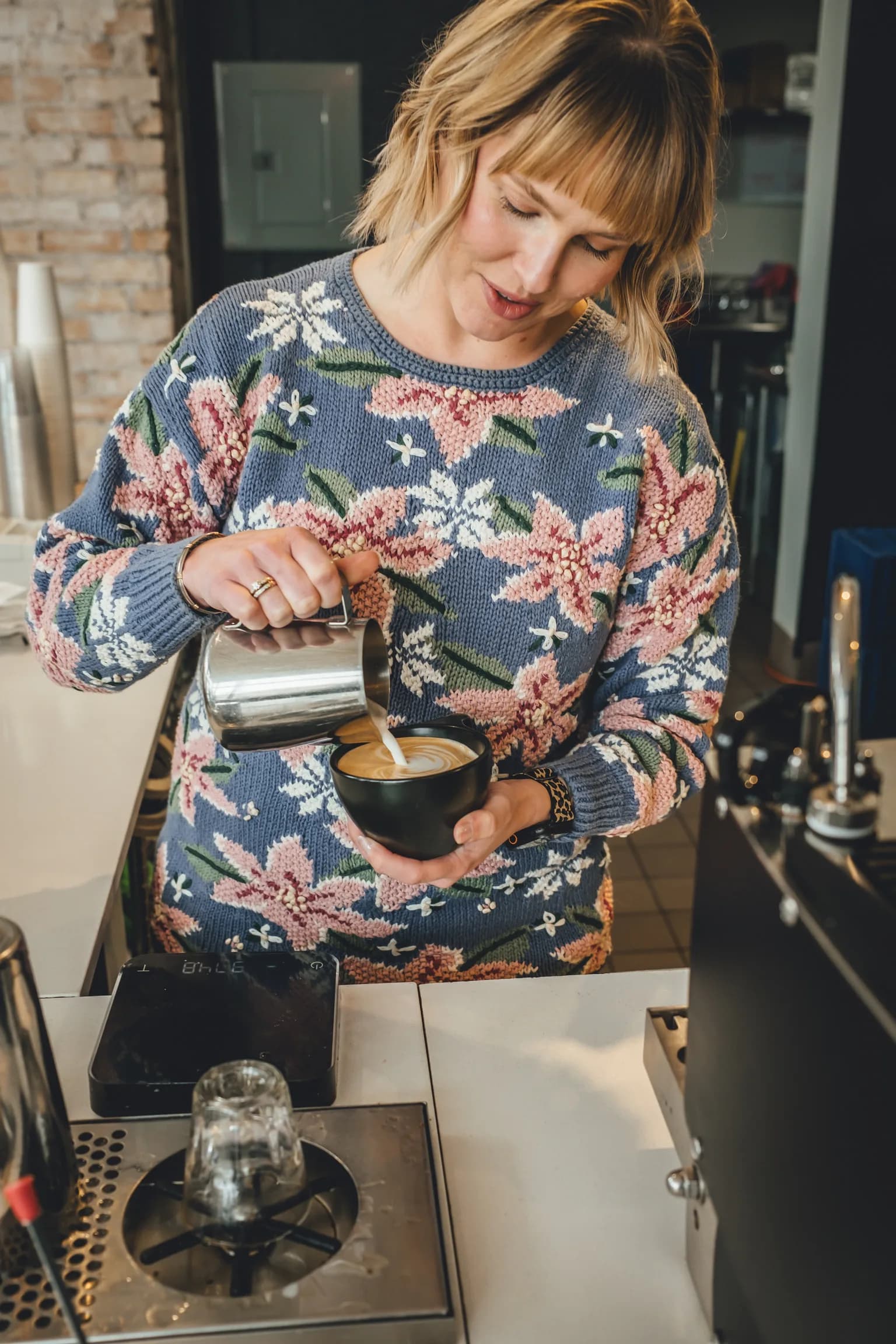 Corner Coffee barista pouring latte art behind the bar