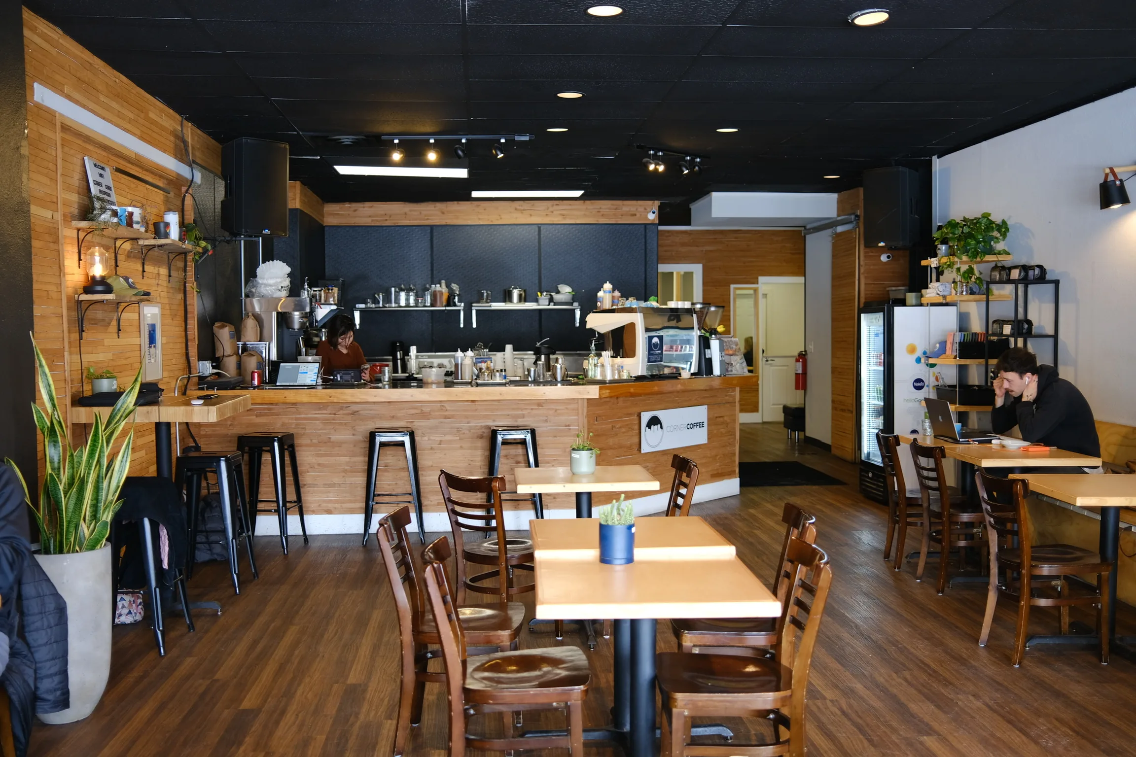 Corner Coffee Camden counter and seating area with warm wood interior