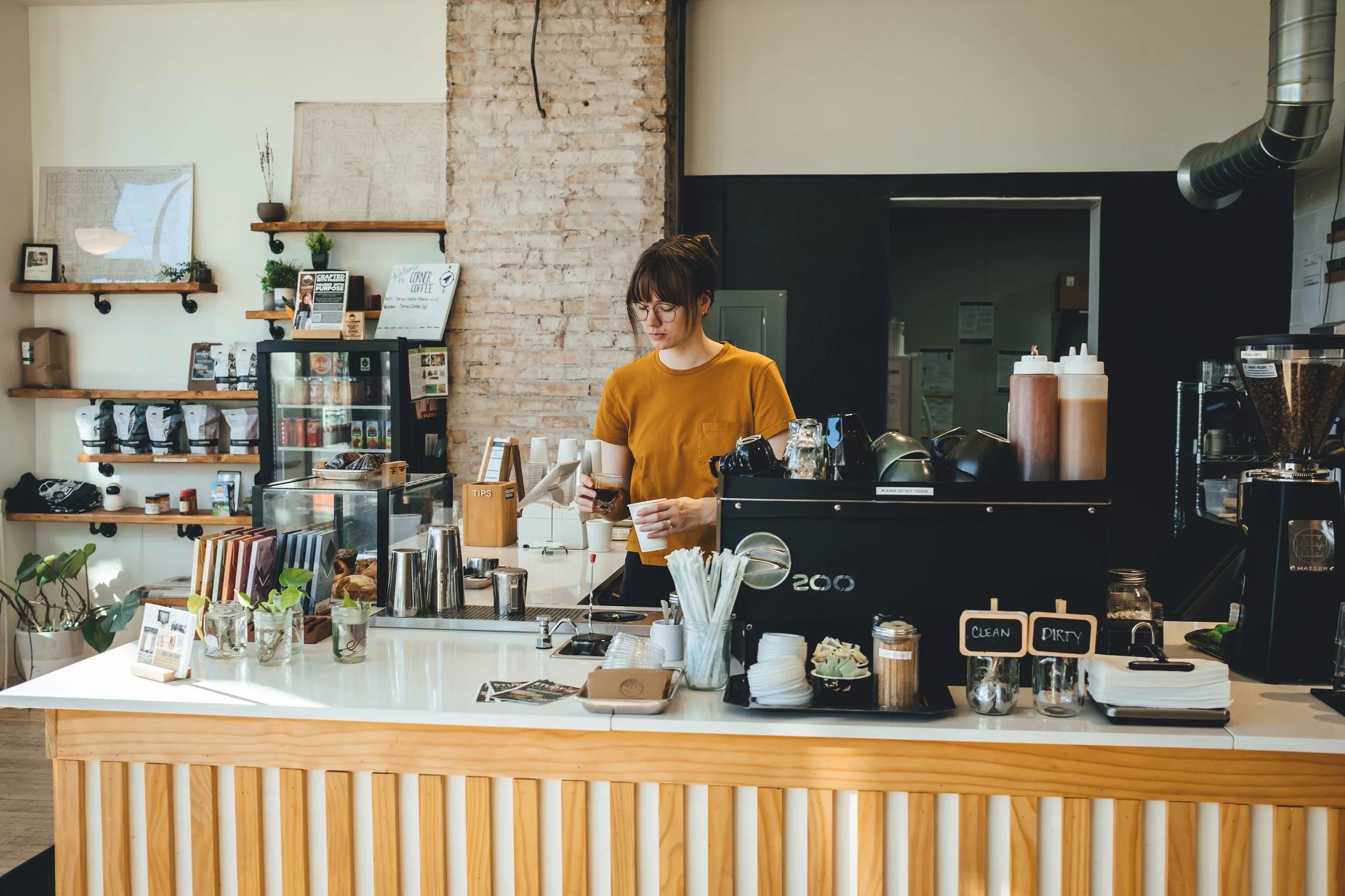 Corner Coffee Northeast barista preparing drinks behind the cafe counter